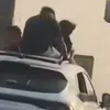 أشخاص تقف فوق سيارة
