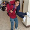 طالب يحمل زميله من ذوى الهمم بسوهاج