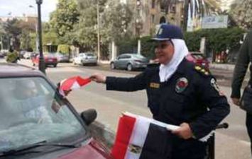 الشرطة توزع الأعلام والهدايا على المواطنين