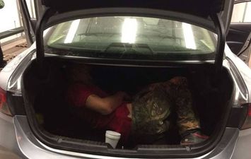  امرأة تضع ابنها في صندوق سيارة