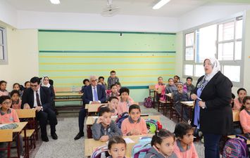وزير التعليم جالسا بين الطلاب