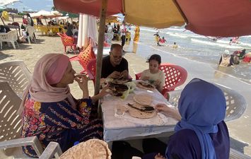 الاستمتاع بتناول وجبة السمك المشوى على شاطىء بورسعيد