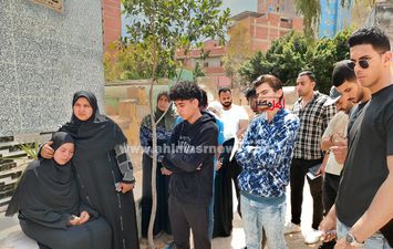 والدة وأصدقاء الطالب عبد الله أمام قبره 